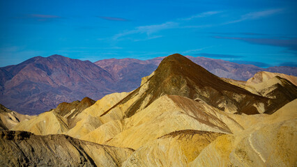 panorama of the mountains in golden canyon during the spring sunrise; the famous coloured mountains which can be seen from zabriskie point; hiking in golden canyon in death valley national park