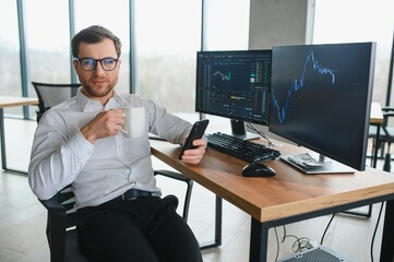 Serious business man trader analyst looking at computer monitor, investor broker analyzing indexes, financial chart trading online investment data on cryptocurrency stock market graph on pc screen.