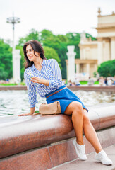 Young beautiful brunette girl in summer street