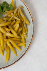 jalapeno close up on a plate with herbs and lemon on a gray stone background