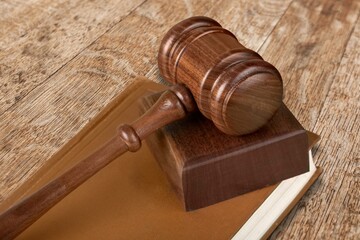 Law book and wooden gavel on desk