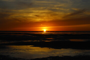 Fototapeta na wymiar Sunset on the North Sea in the Lower Saxony Wadden Sea off Cuxhaven