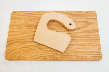 Сhildren's wooden knife on cutting board	