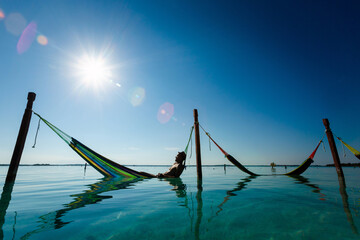 Man on hammock in Bacalar lagoon Mexico - 574405802