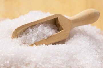Coarse salt and a wooden scoop.