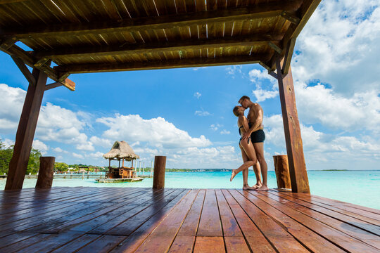 Couple relaxing on a pier Bacalar lagoon Mexico