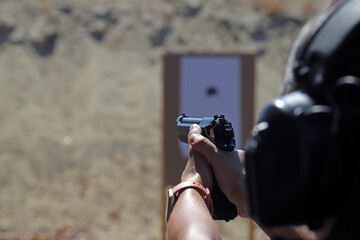 Fixed target gunshot.
Target shooting with a pistol, practice at the shooting range with a...