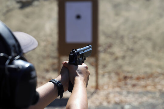 Fixed target gunshot.
Target shooting with a pistol, practice at the shooting range with a short-barreled firearm.