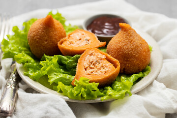 traditional brasilian fried drumsticks Coxinha de frango on dish