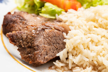 Baked fried meat with boiled rice and fresh salad