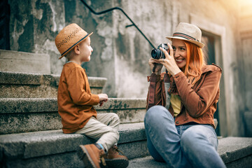 Beautiful female photographer using her camera outdoors