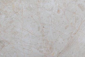White marble tiles with beige patterns and real scratches. White textured background made of marble.