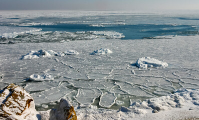 The Black Sea is frozen, ice floes float along the shore. Climate change, harsh winter
