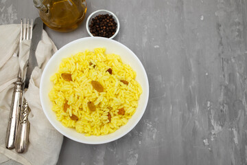 Yellow rice with dried fruit in white bowl