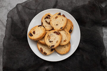 Mini round toasts of bread with raisins on dish