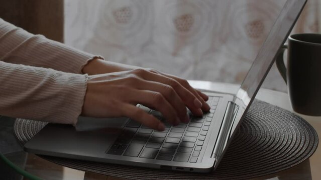 Gig economy. Close up shot of lady freelancer working online on laptop, hands typing on computer keyboard, free space