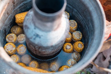 Cooking boiled corn on the street. Fast food.
