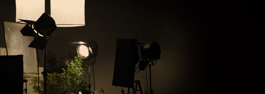 Film light for video production camera in studio set. Use as studio photo shoot light. Big LED spot light 5000w and diffuser or black panel create light like sun light can make daytime or golden hour