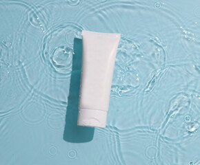 Skin care product mock up on water surface. Water ripples from top angle. Flat lay of ocean waves...