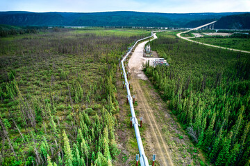 Aerial Drone image of the Alaska Pipeline approaching the Yukon river and the Yukon River Bridge...