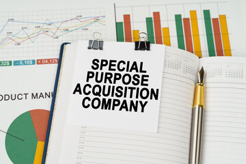 On the business charts is a notepad with the inscription - Special Purpose Acquisition Company