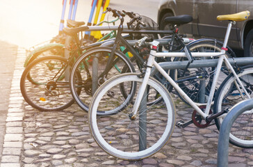 Naklejka na ściany i meble Bicycle parking in the city center on the cobblestone pavement