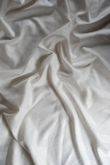 Abstract beige fabric background, satin stripe texture, wavy folds of elegant expensive fabric