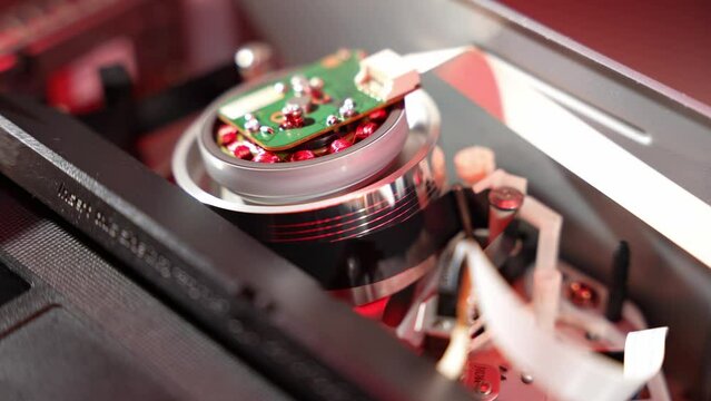 Old video recorder the process of stretching the film on the video head close-up