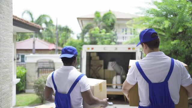 Team of employee workers with a truck car moving house for customers, delivering boxes with uniform.Vehicle transportation. Shipping and packaging business occupation service company. People lifestyle