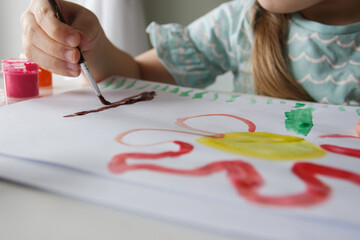 Little child draws with watercolor, concept of education in the kindergarten
