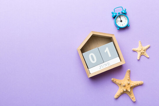 June 1th. Image of june 1 wooden calendar on colored background. Summer day. Empty space for text