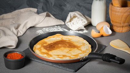 Traditional Russian pancakes with butter and red caviar