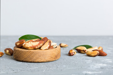 Fresh healthy Brazil nuts in bowl on colored table background. Top view Healthy eating bertholletia concept. Super foods