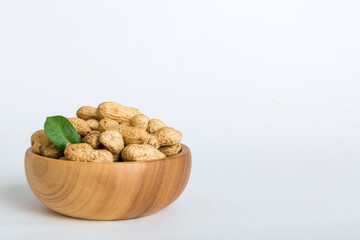 Fresh healthy peanuts in bowl on colored table background. Top view Healthy eating bertholletia concept. Super foods