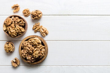 Obraz na płótnie Canvas Fresh healthy walnuts in bowl on colored table background. Top view Healthy eating bertholletia concept. Super foods