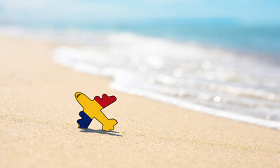 Vacation on the coast of Romania. Airplane in the colors of the flag of Romania on the seashore