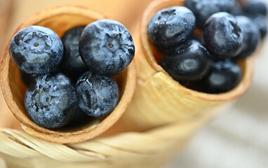 blue blueberries in an ice cream waffle cone. healthy fruits. copy space. diet