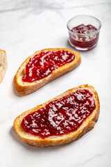 Open Sandwich with toasted sourdough white bread slices and raspberry jam