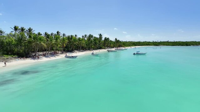 tourists enjoying the beach on the island of saona in punta cana