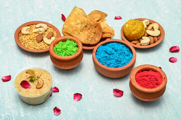 top view of colorful traditional holi powder in bowls isolated on dark background.Space for text . happy holi.Concept Indian color festival called Holi