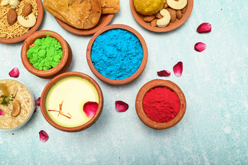 Obraz na płótnie Canvas top view of colorful traditional holi powder in bowls isolated on dark background.Space for text . happy holi.Concept Indian color festival called Holi