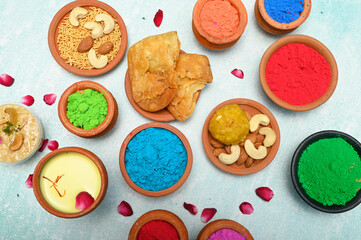 top view of colorful traditional holi powder in bowls isolated on dark background.Space for text . happy holi.Concept Indian color festival called Holi