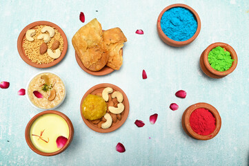 top view of colorful traditional holi powder in bowls isolated on dark background.Space for text . happy holi.Concept Indian color festival called Holi