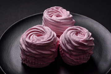 Delicious fresh natural airy marshmallows on a black ceramic plate