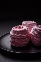 Delicious fresh natural airy marshmallows on a black ceramic plate