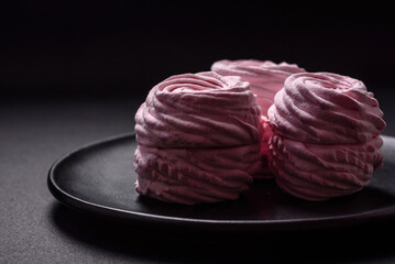 Delicious fresh natural airy marshmallows on a black ceramic plate