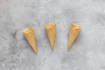 Empty ice cream waffle cones on gray background
