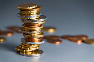 Coins stacked in a slanted pile. Pile of different euro coins and cents
