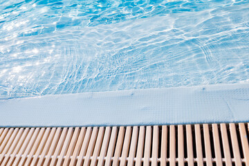 The edge of clear water at a shallow pool