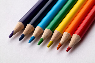 Bright сolored pencils on a white paper background. Blots. Rainbow. Close up. Macro.